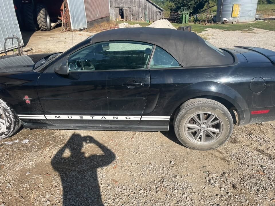 Black Mustang convertible before detailing