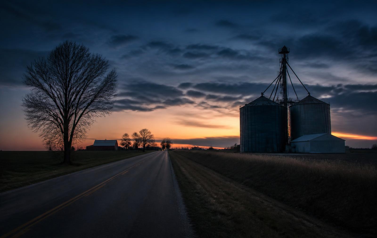 Rural southern Illinois road and grain silos